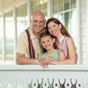 A family of 3 posing for a photo during a portrait session at Walt Disney World Resort