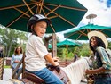 A young Guest enjoying a pony ride at Disney’s Fort Wilderness Resort and Campground at Walt Disney World Resort