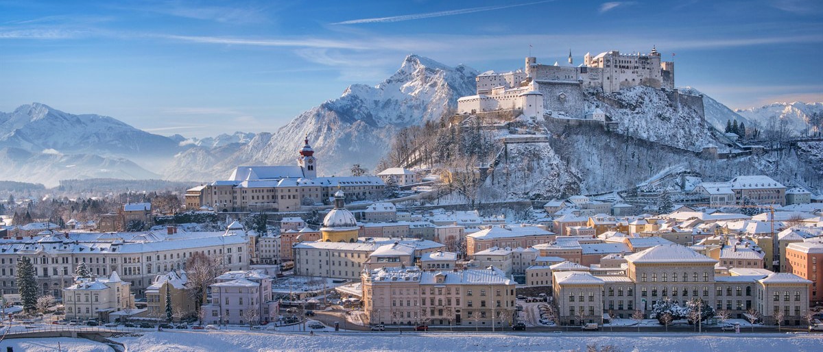 Picturesque Salzburg with snow covering the streets, buildings and surrounding mountains
Picturesque Salzburg with snow covering the streets, buildings and surrounding mountains