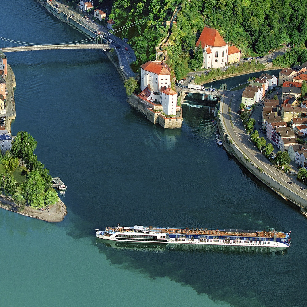An AmaWaterways ship cruises down the Danube River near shores housing beautiful, quaint towns An AmaWaterways ship cruises down the Danube River near shores housing beautiful, quaint towns
