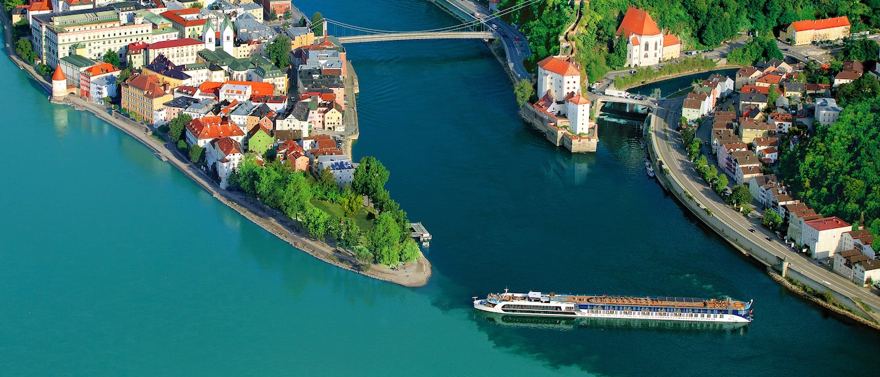 An AmaWaterways ship cruises down the Danube River near shores housing beautiful, quaint towns An AmaWaterways ship cruises down the Danube River near shores housing beautiful, quaint towns