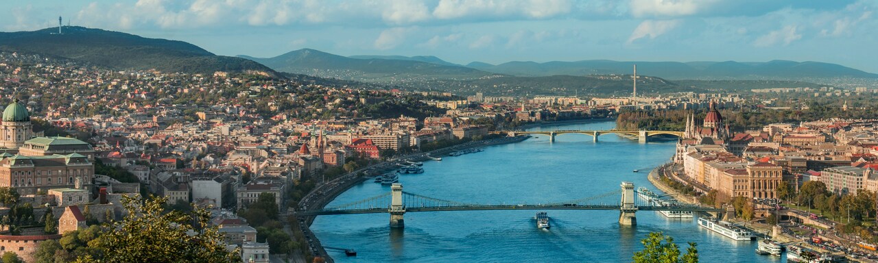 The Danube River with 2 bridges and city buildings on both shores The Danube River with 2 bridges and city buildings on both shores