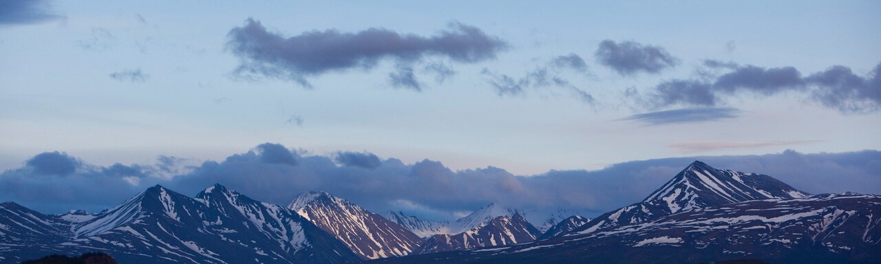 A scenic mountain range at twilight A scenic mountain range at twilight