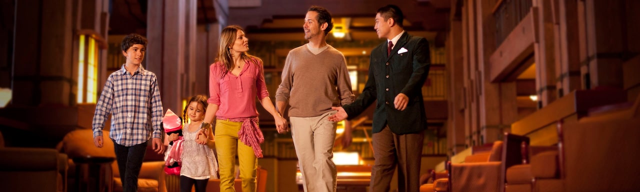 A male Cast Member leads a family of 4 through the lobby of Disney’s Grand Californian Hotel & Spa at Disneyland Resort A male Cast Member leads a family of 4 through the lobby of Disney’s Grand Californian Hotel & Spa at Disneyland Resort