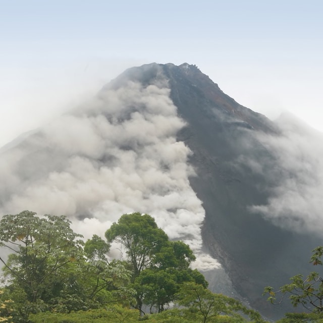 Mist surrounds the crater of the Arenal volcano