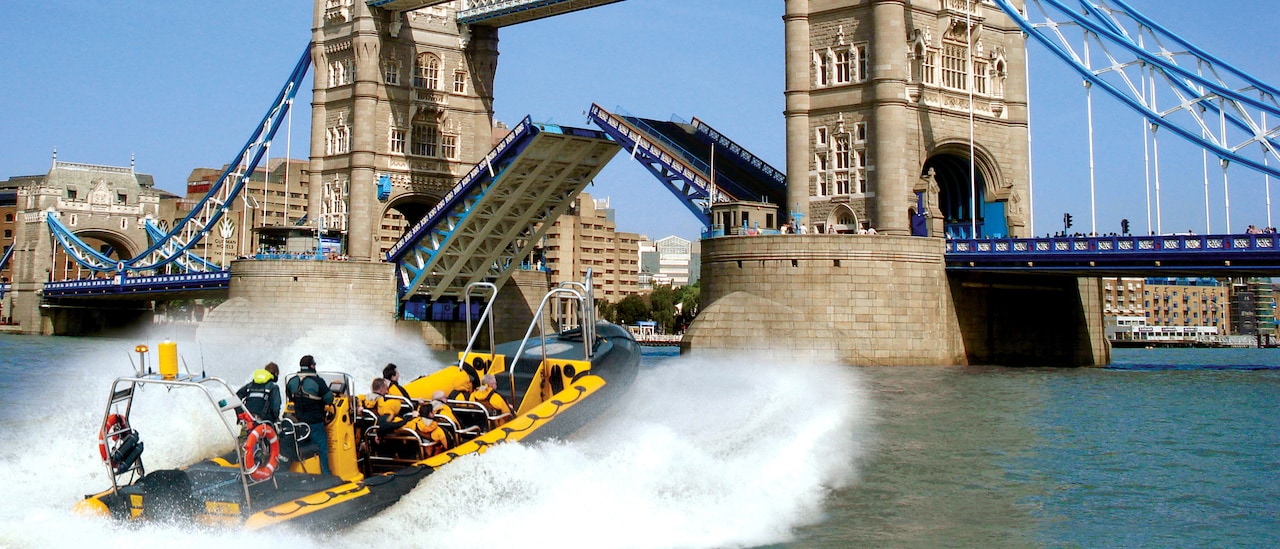 A speedboat races towards Tower Bridge on the Thames River