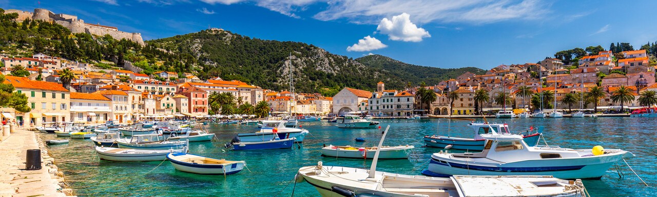 Boats anchored in the bay of a hillside village along the Adriatic Sea