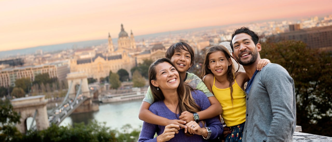 A family of 4 above a city look around with a sense of excitement A family of 4 above a city look around with a sense of excitement