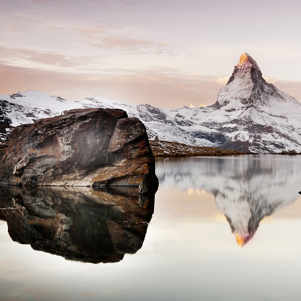 The famed, snow dusted Matterhorn and a rock studded lake