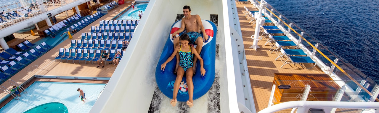 Two Guests ride a boat down the AquaDuck water coaster on the Disney Fantasy cruise ship Two Guests ride a boat down the AquaDuck water coaster on the Disney Fantasy cruise ship