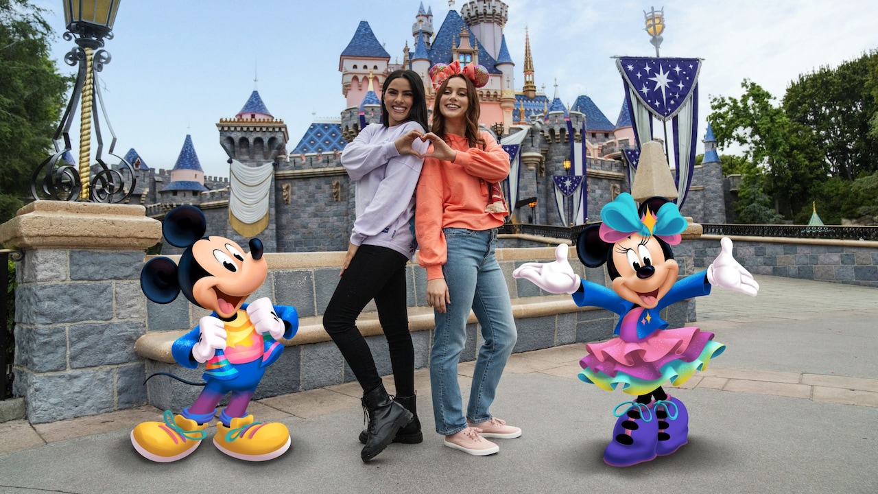 Two Guests posing in front of Sleeping Beauty Castle with a Disney Photo Pass Lens featuring Mickey Mouse and Minnie Mouse