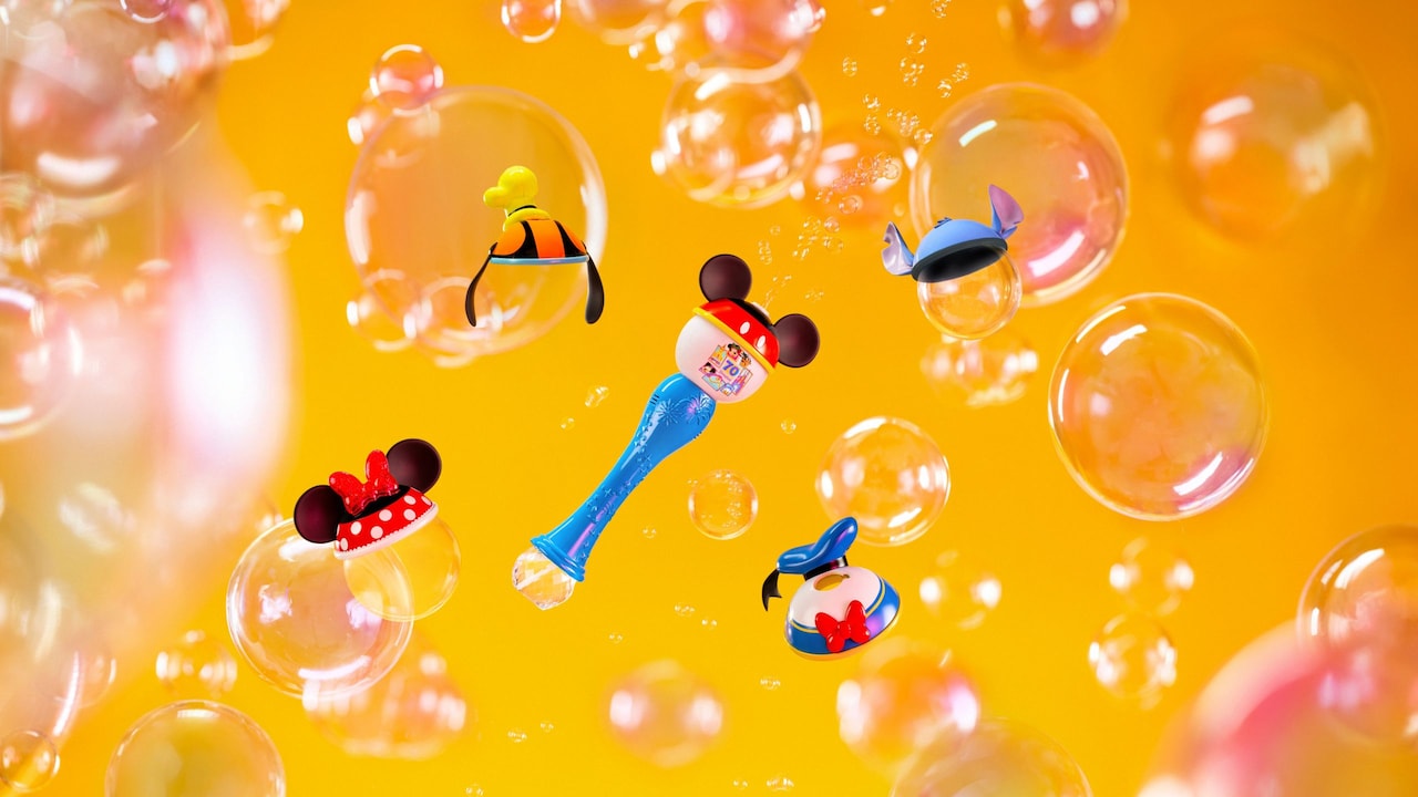 Assorted Disneyland Resort 70th Celebration mini character-themed bubble wand toppers and accessories floating amid bubbles