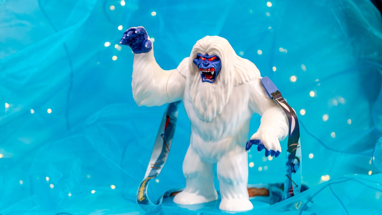 A sipper on a lanyard featuring the Abominable Snowman baring his fangs, with one clawed paw raised