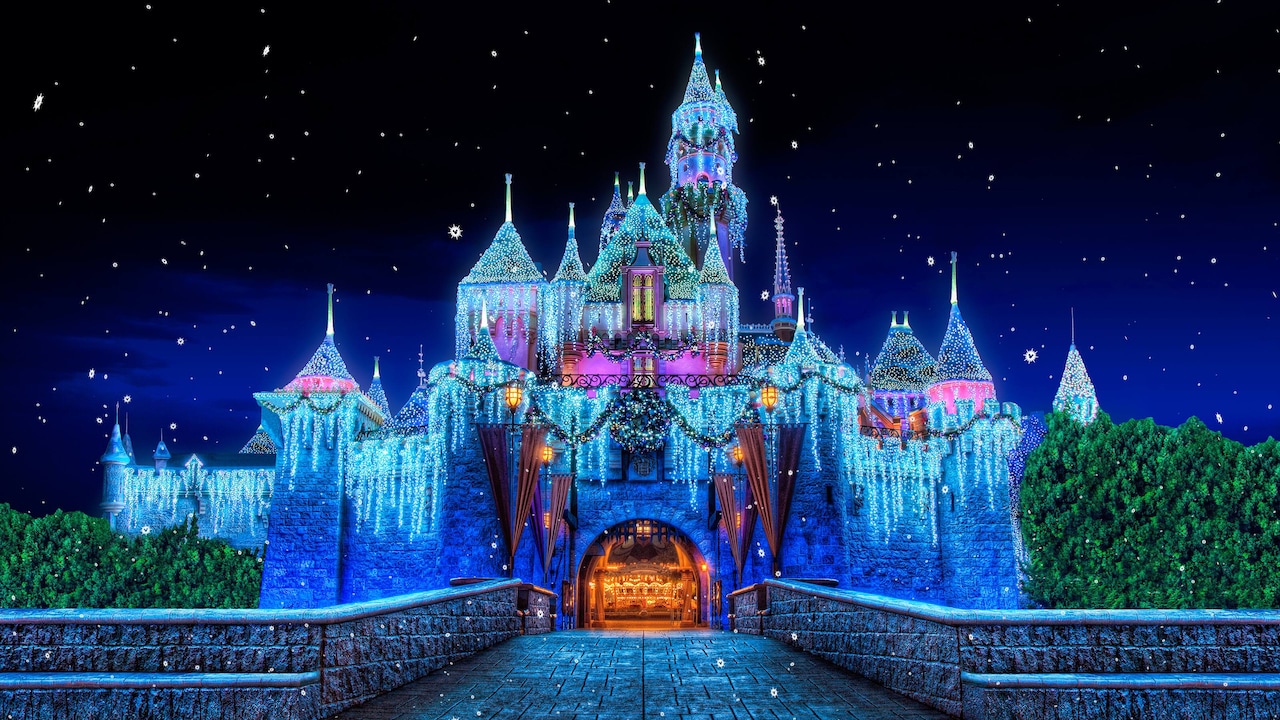 Sleeping Beauty Castle decorated with lights during a nighttime winter celebration