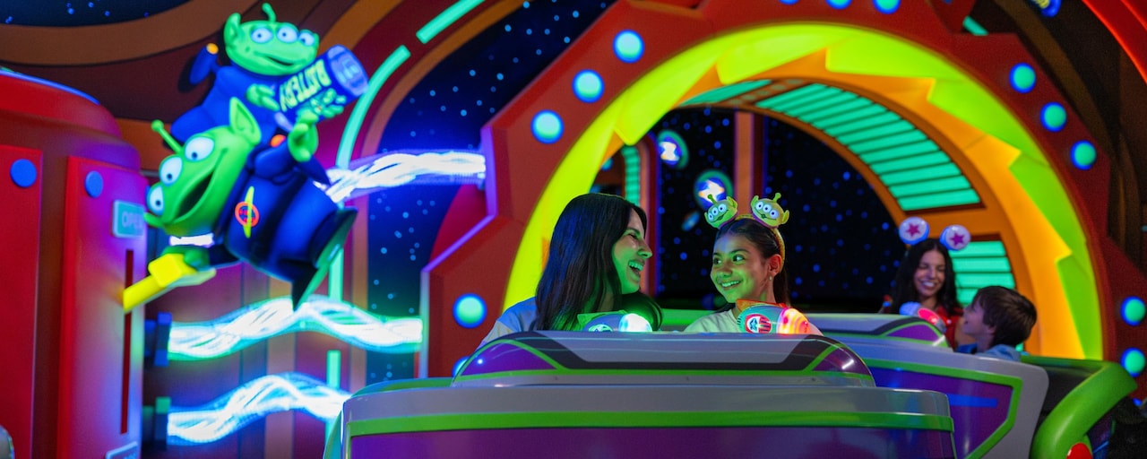 Guests smiling as they ride Buzz Lightyear's Space Ranger Spin at Magic Kingdom park