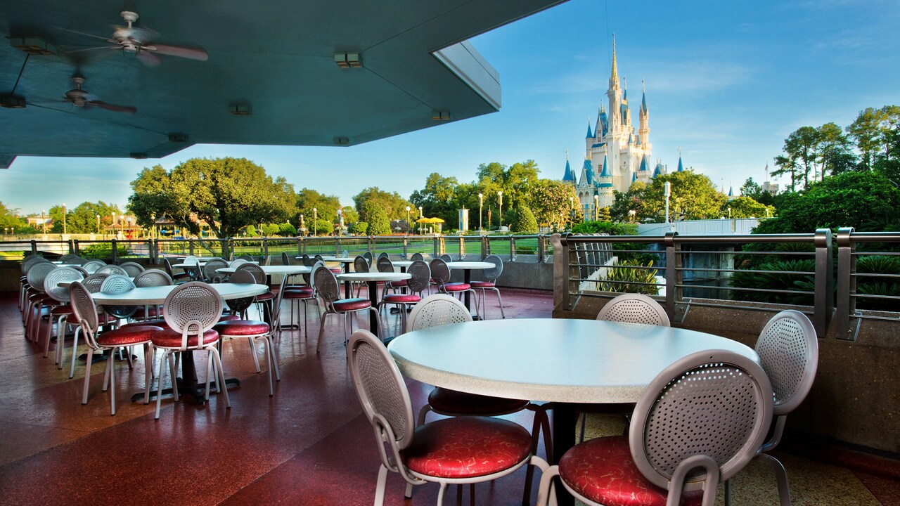 A seating area with a view of Cinderella Castle