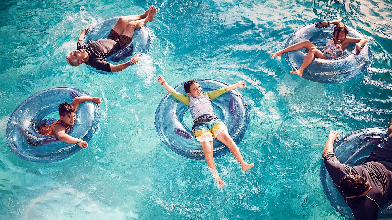 A family of five float on inner tubes in a pool