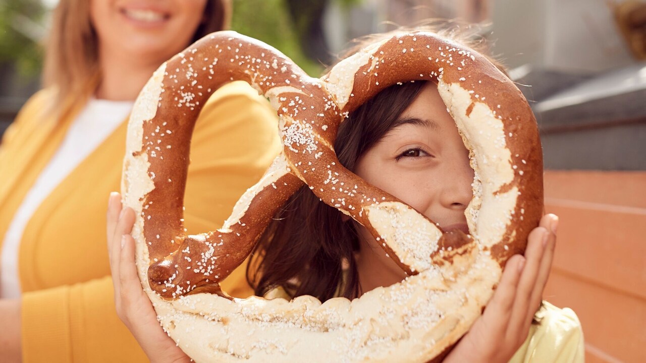 Una niña ve a través de un enorme pretzel