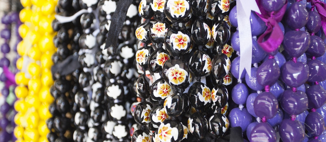 A display of beaded lei necklaces