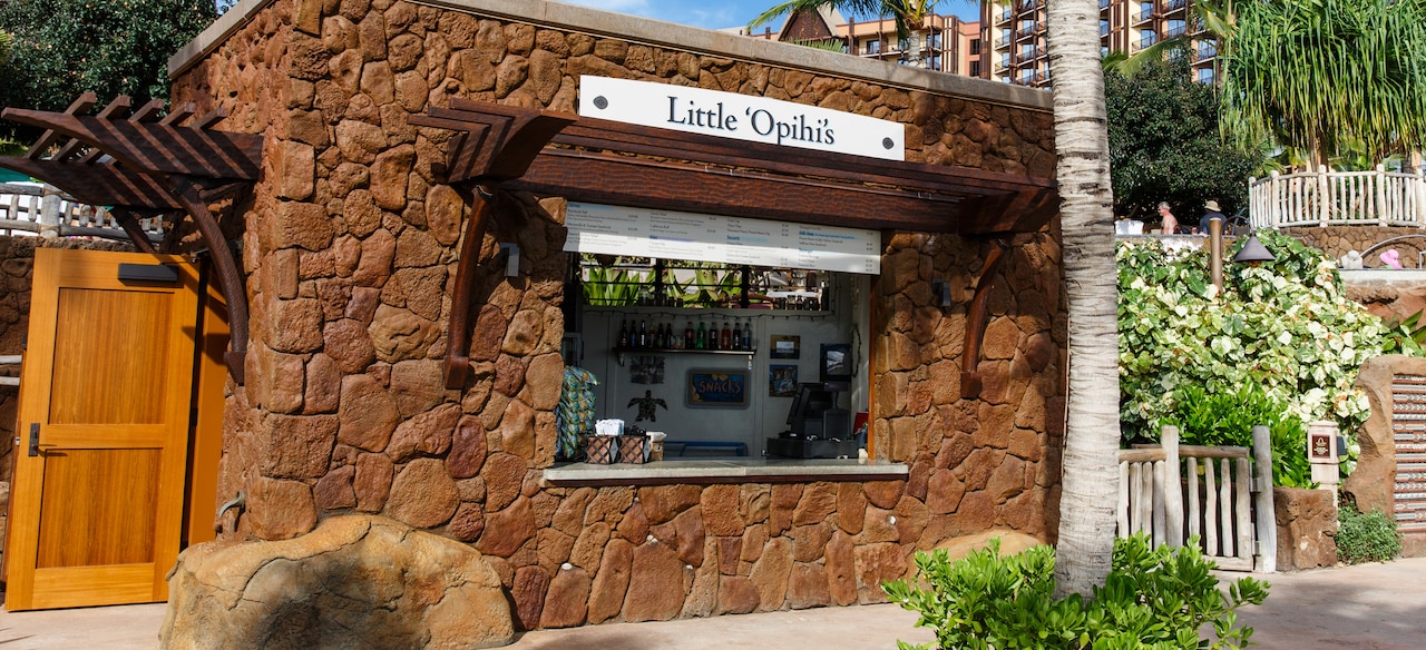 The exterior of Little 'Opihi's, a rectangular, stone-walled shack with a quick-service window