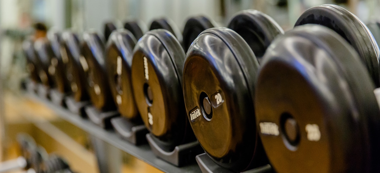A row of racked free weights