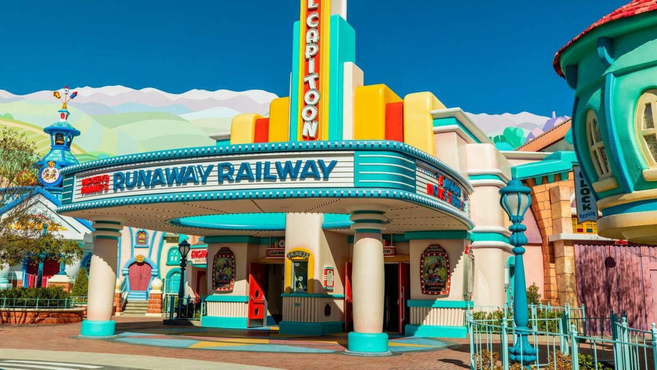 Una ilustración de una marquesina de película que muestra Mickey and Minnie’s Runaway Railway, con Mickey y Minnie saludando a los Visitantes