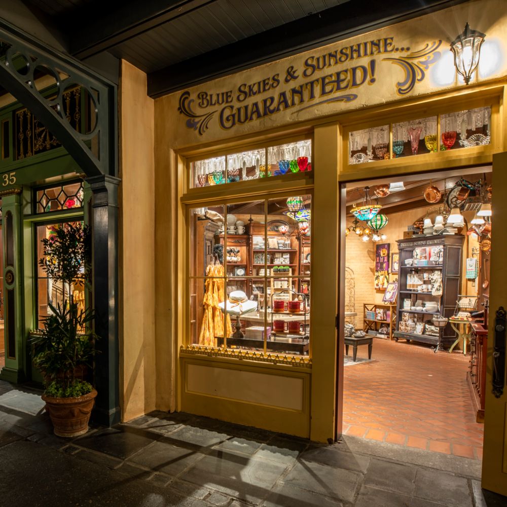 The facade of a New Orleans themed shop with the words 'Blue Skies & Sunshine Guaranteed' on the wall