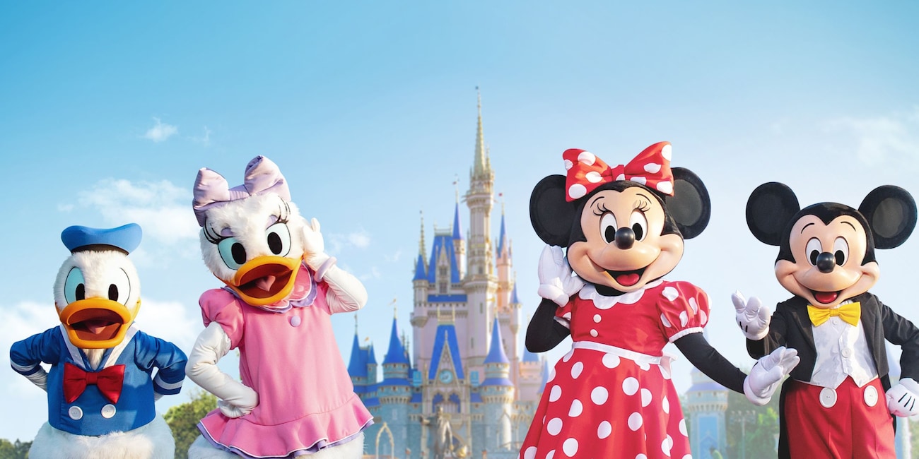 Mickey Mouse, Minnie Mouse, Donald Duck and Daisy Duck posing for a photo near Cinderella Castle at Magic Kingdom park