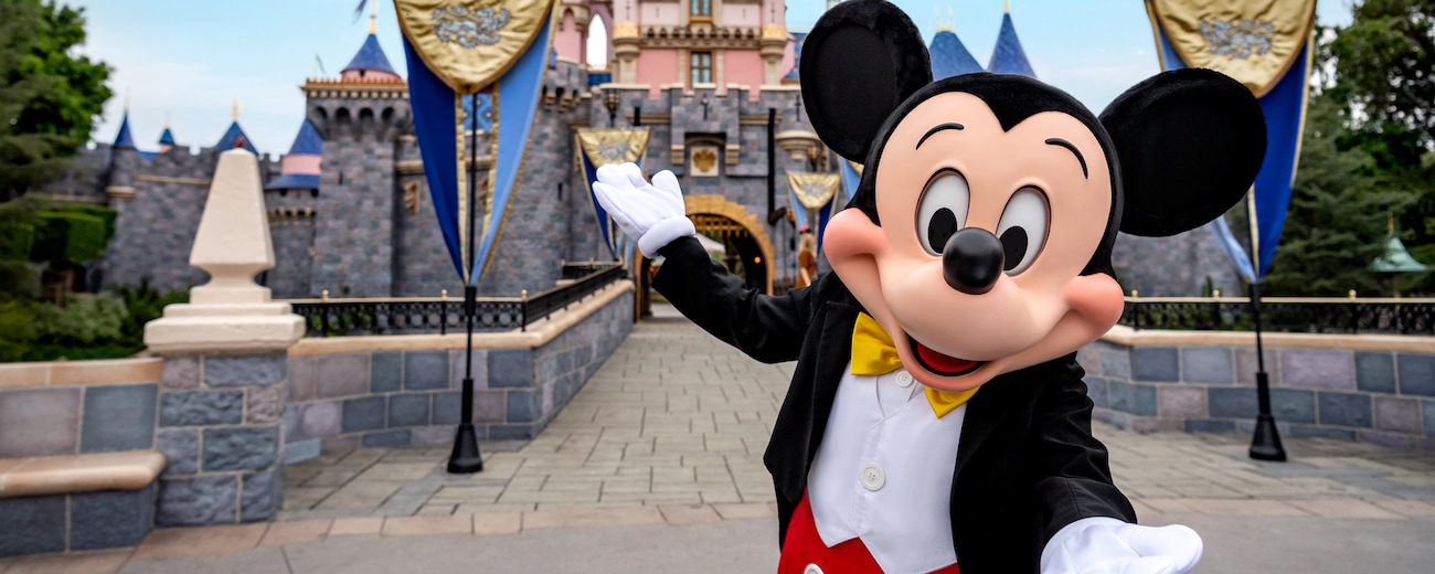Mickey, in front of the bridge leading to Sleeping Beauty Castle, welcomes you to Disneyland Park