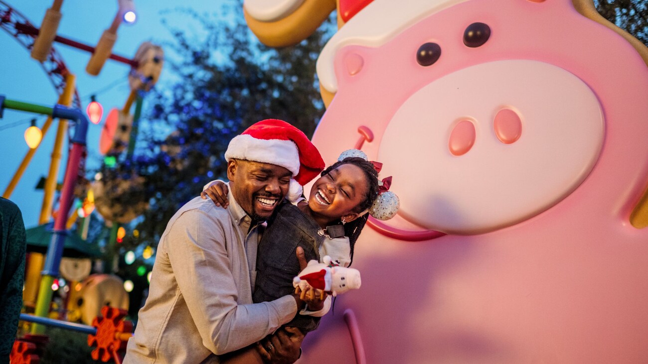 A father and daughter, and Hamm from the Disney and Pixar animated film Toy Story