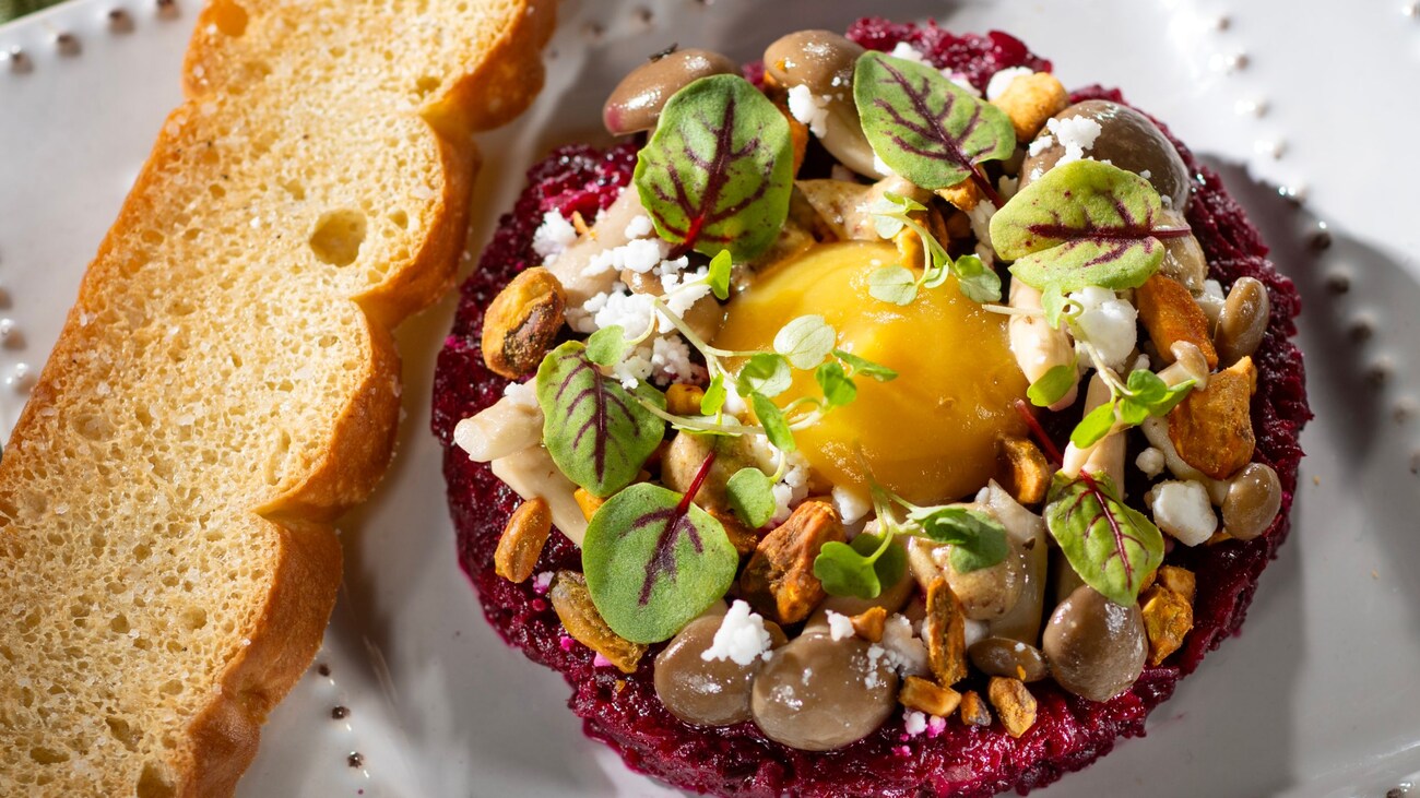 Citrus braised Beet Tartare with golden beet egg yolk, mustard vinaigrette, pickled mustard seeds, pickled mushrooms, spiced pistachios and feta snow
