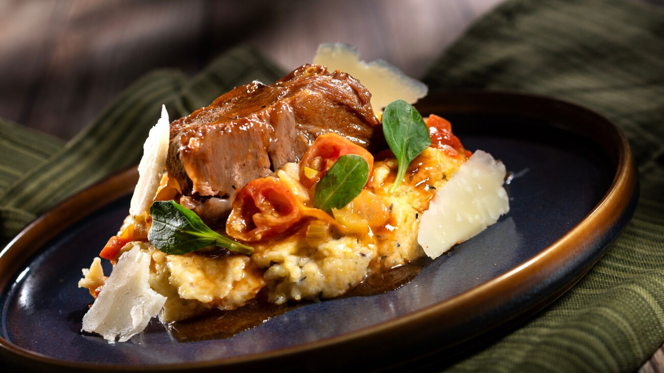 Red Wine Braised Beef Short Rib served over goat cheese polenta, topped with tomato ragù, shaved Pecorino cheese and petit herbs