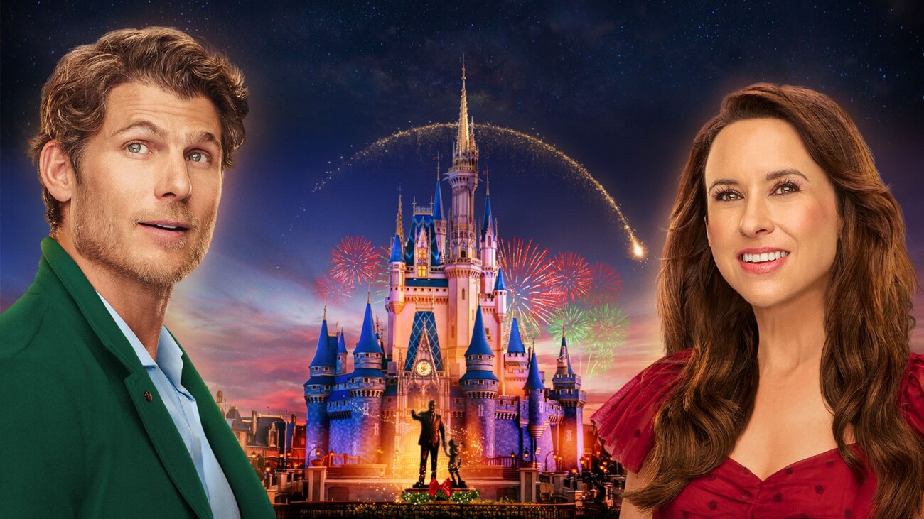 Lindsey and Philip from Holiday Ever After a Disney World Wish Come True near a fireworks display at Cinderella Castle