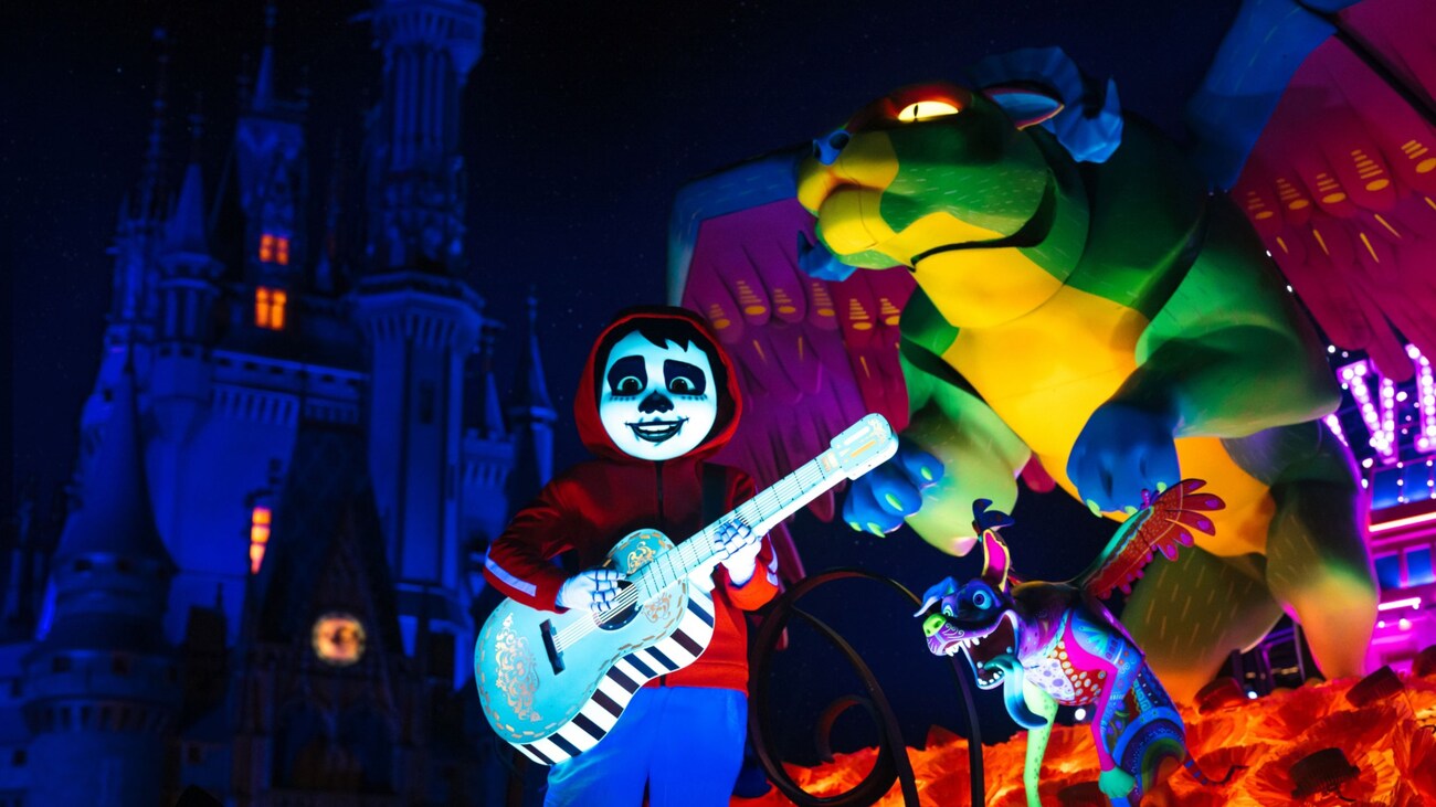 Miguel from Coco performing on a parade float near Cinderella Castle at Magic Kingdom park