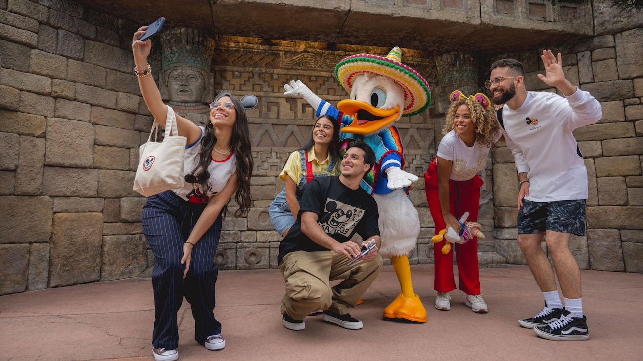 Wearing his 3 Caballeros garb, Donald Duck poses for a selfie with Guests at Epcot’s Mexico Pavilion