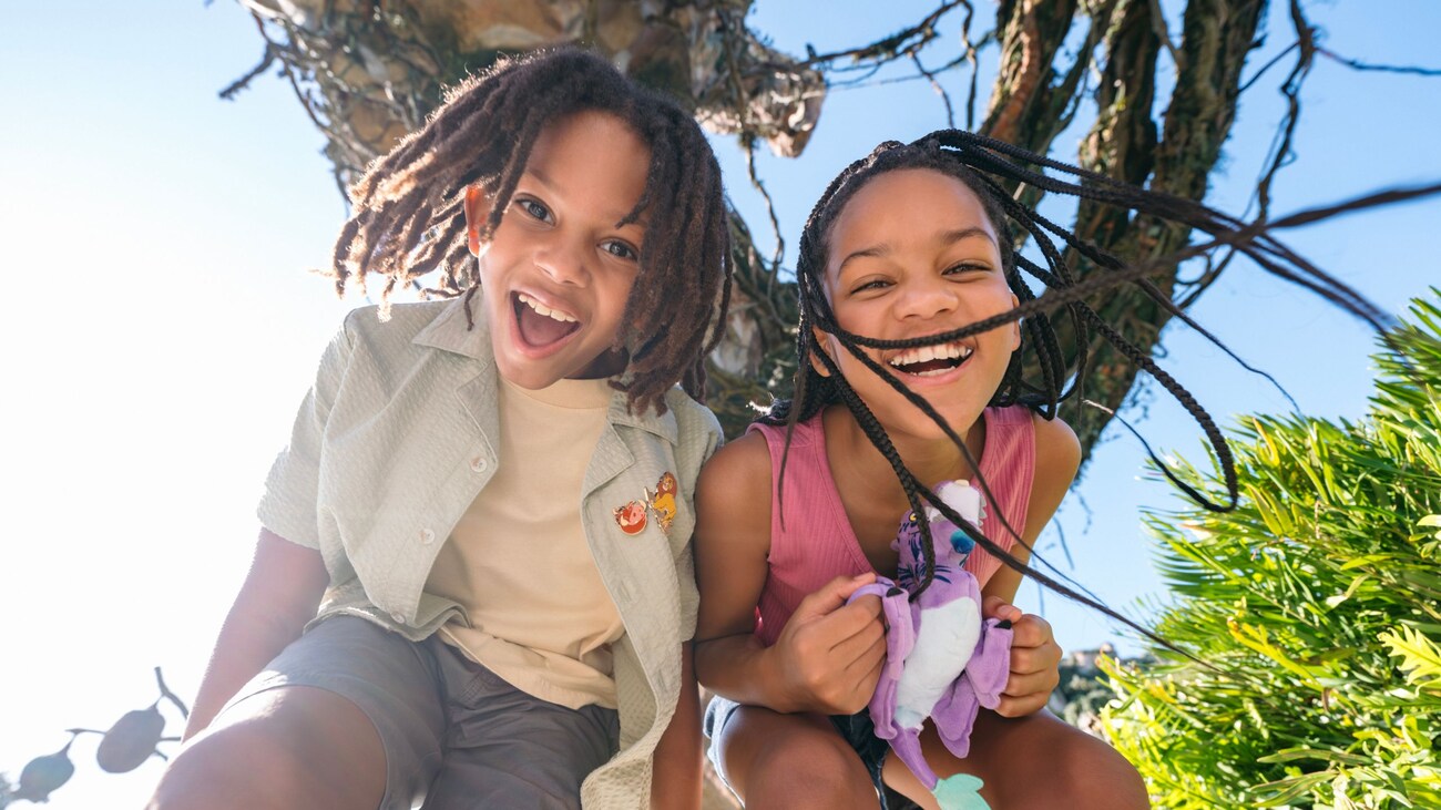 2 smiling children surrounded by lush foliage in Pandora – The World of Avatar at Disney's Animal Kingdom theme par