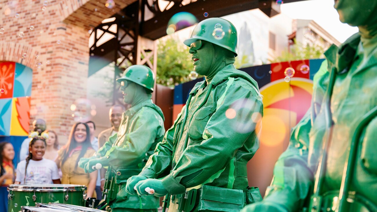 The Green Army Drum Corps stand in performing in front of guests