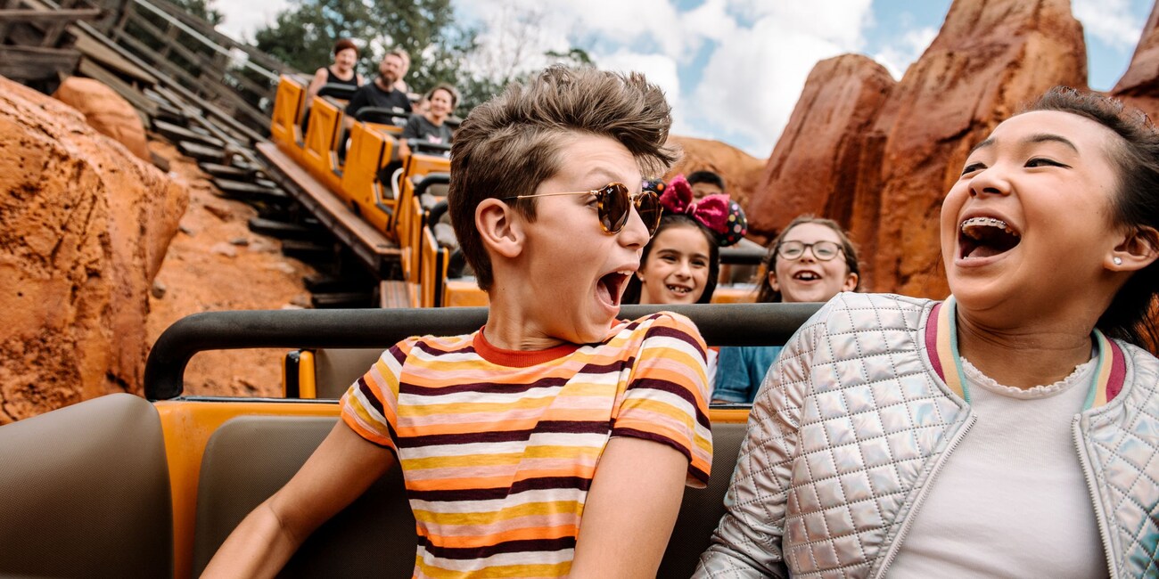 Children laughing with delight while riding the Big Thunder Mountain coaster at Magic Kingdom park
