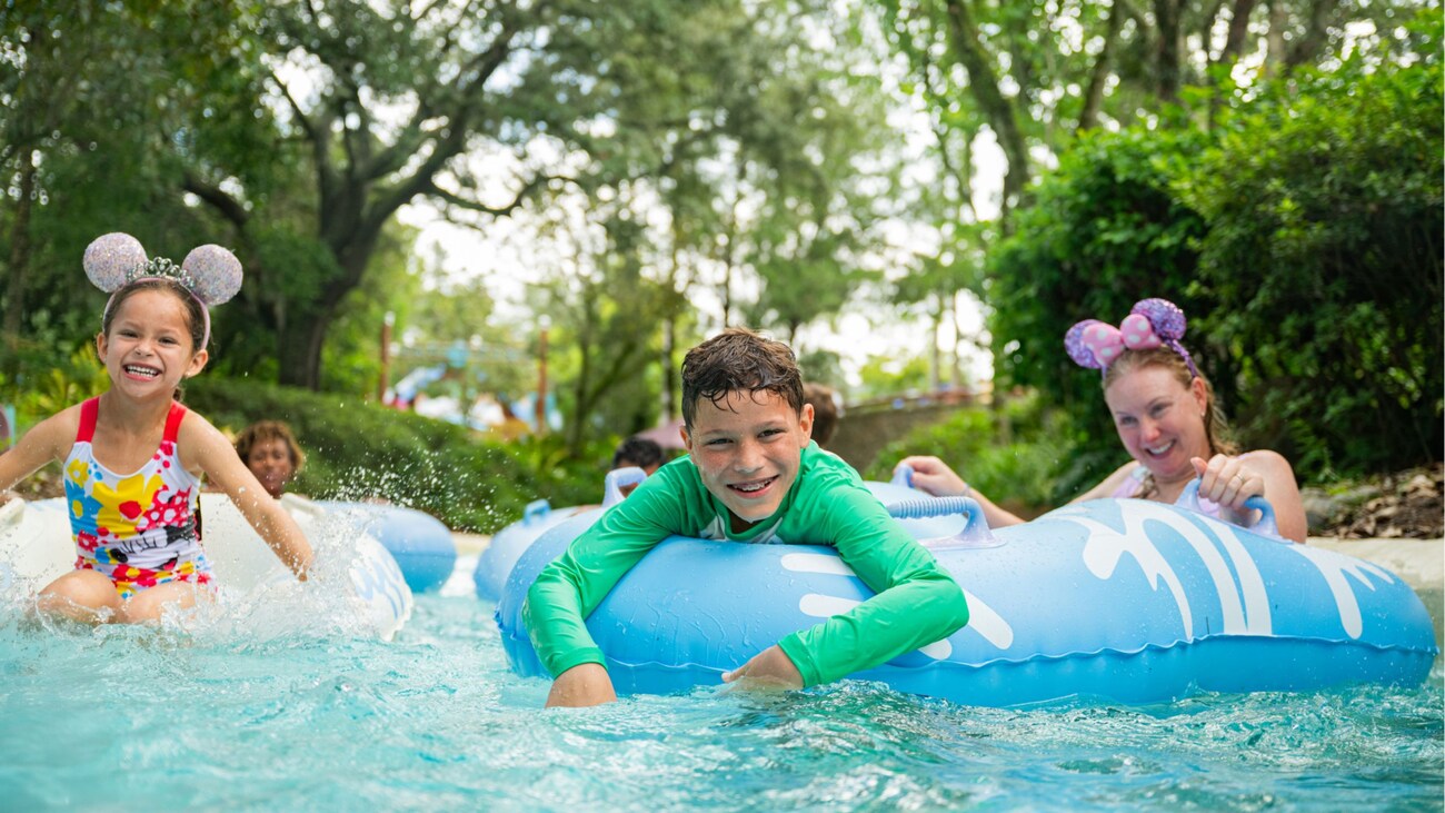 4 children floating on inner tubes in a lazy river