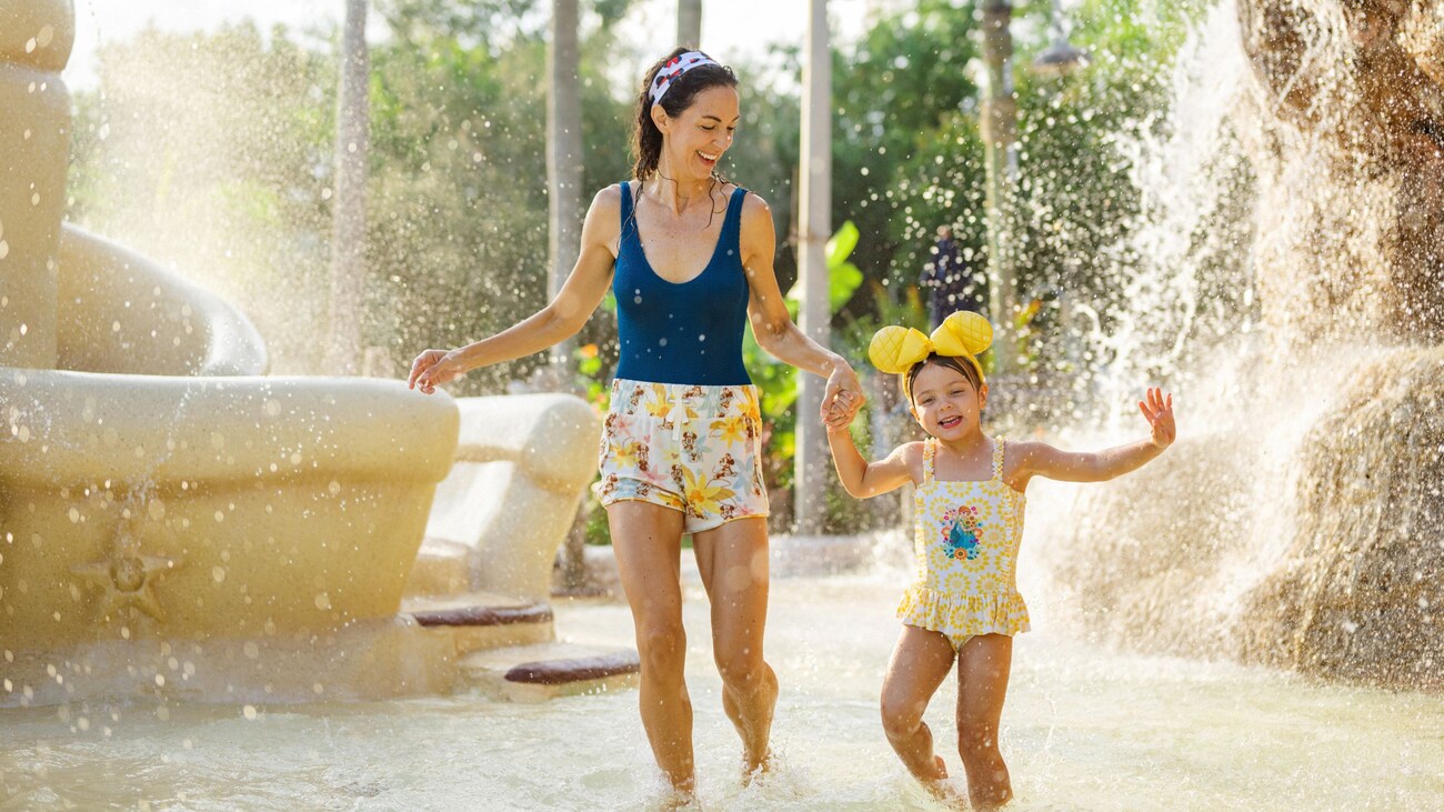 A mother and her young daughter playing at Ketchakiddee Creek at Disney’s Typhoon Lagoon water park