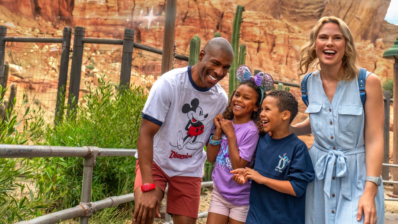 A family of 4 walking through the entrance of Radiator Springs Racers