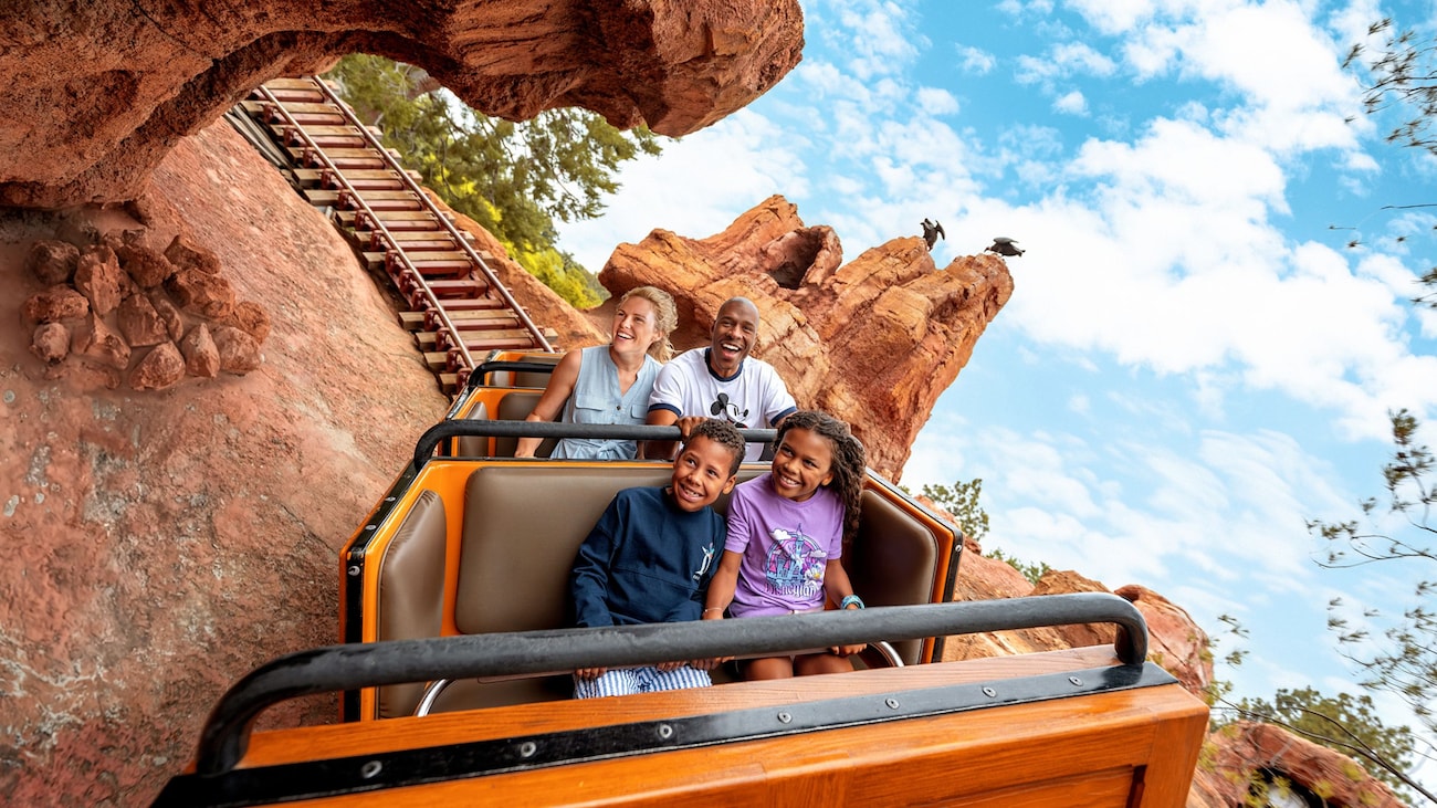 A family of 4 riding Big Thunder Mountain Railroad