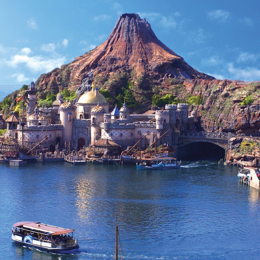 The giant volcano, Mt. Prometheus, looms over a domed building on Arabian Coast Island at Tokyo DisneySea