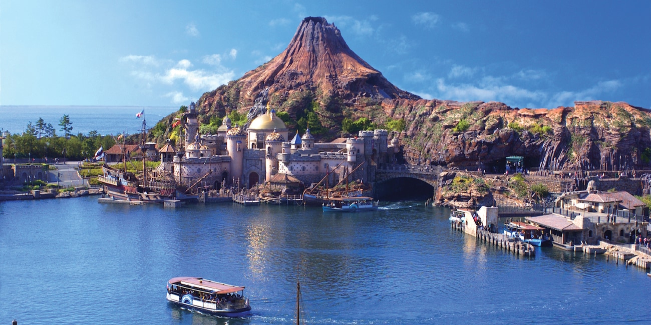 The giant volcano, Mt. Prometheus, looms over a domed building on Arabian Coast Island at Tokyo DisneySea
