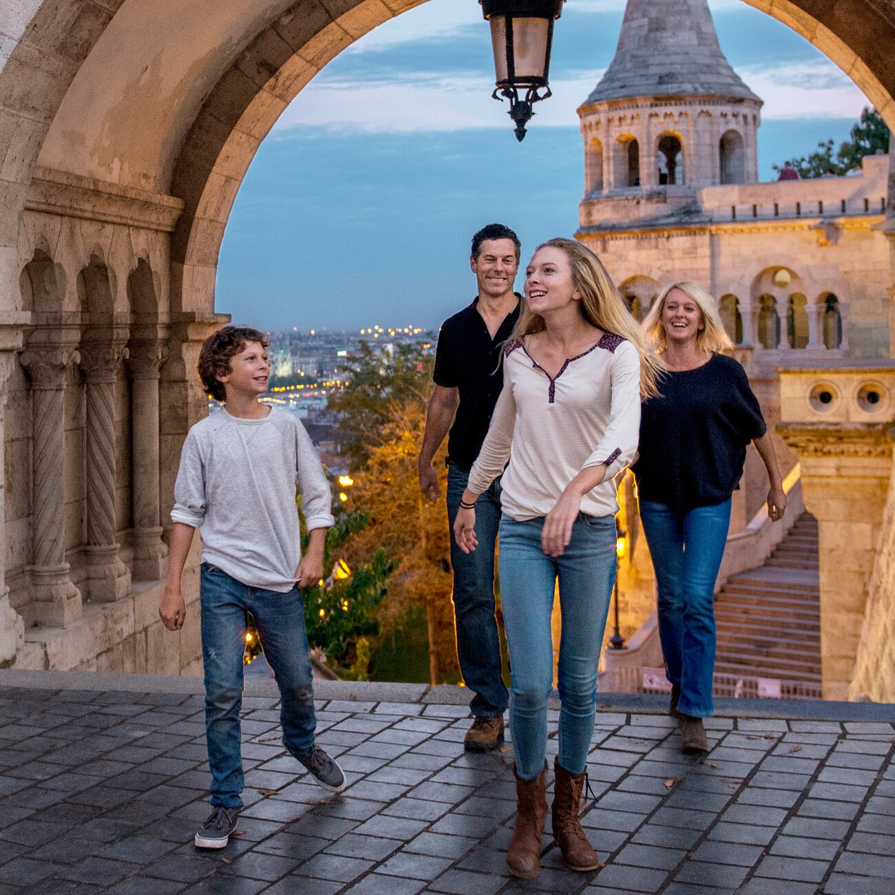 A city featuring a church with spires, skyscrapers and a covered bridge that spans the Rhine River