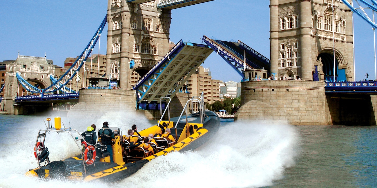 A speedboat races towards Tower Bridge on the Thames River