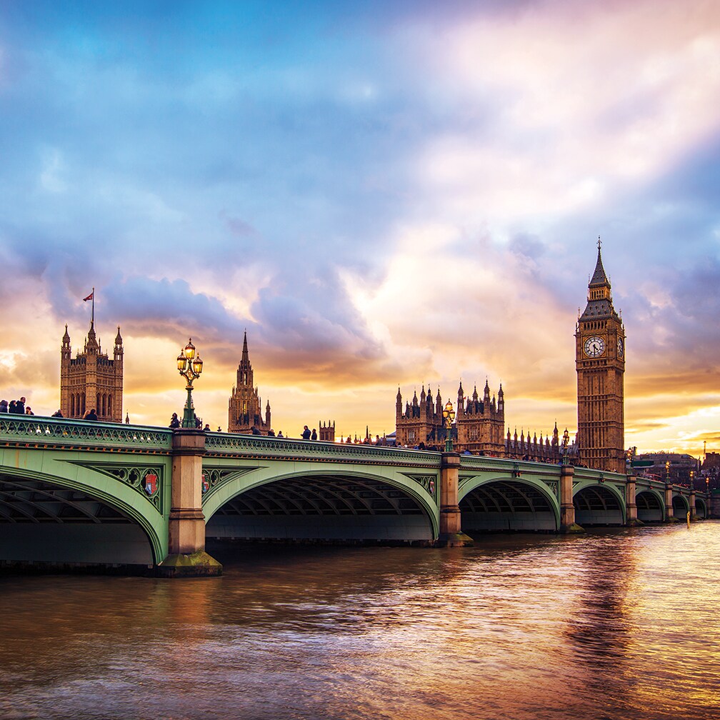The River Thames flows under London Bridge near Big Ben