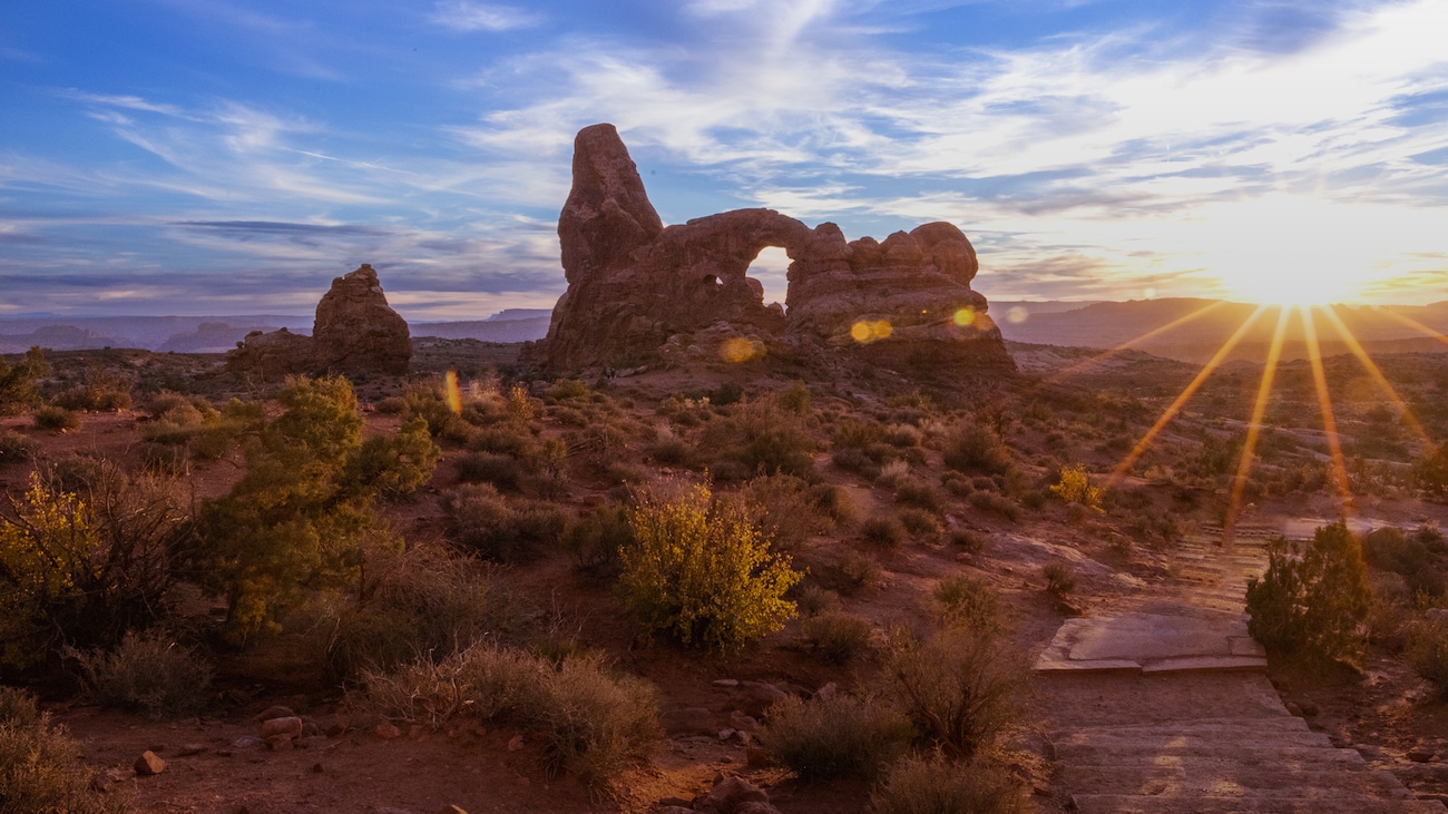 A sandstone arch in Arches National Park at sunrise