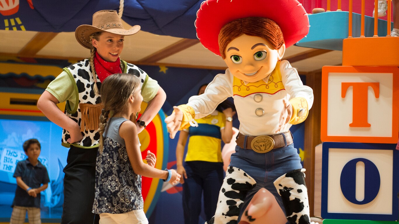 Jessie from Toy Story extends a handshake to a little girl as a Disney counselor looks on
