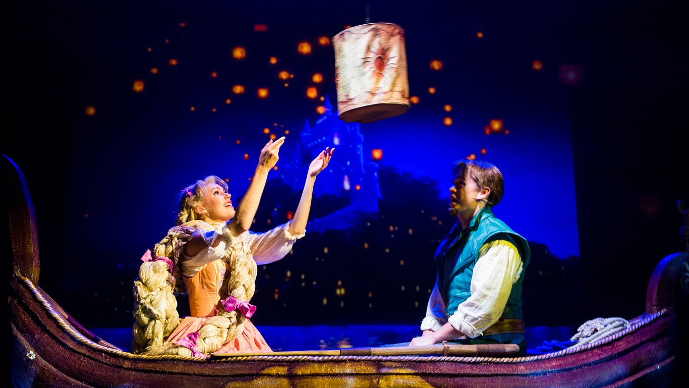 Sitting in a small boat, Rapunzel and Flynn watch the lantern that is between them float up into the night sky, which is filled with many more glowing lanterns